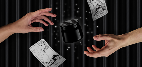 Black jar of silver face cream with hands reach to it from either side, surrounded by illustrated stars and a floating archetype card
