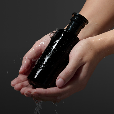 Hands holding bottle of Argentum face tonic