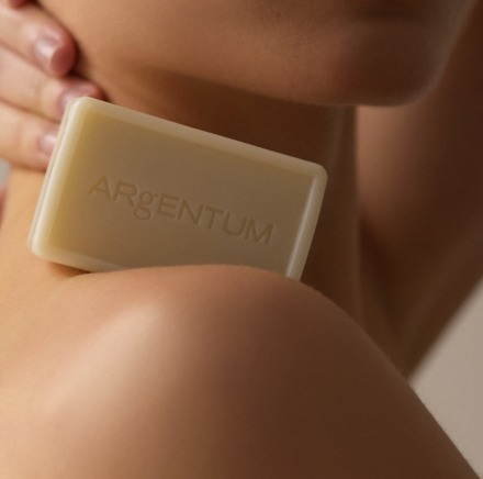 le savon lune, silver facial cleansing bar, balanced on a shoulder