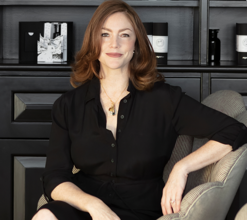 Joy Isaacs, Argentum founder and CEO, sat on a chair in the Argentum Notting Hill boutique