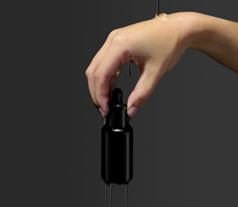 Hand holding a bottle of organic face oil