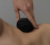 Jar of silver face cream balanced on woman's waist